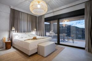 a bedroom with a white bed and a large window at Akissare in Kámpos