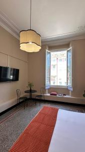 a living room with a table and a flat screen tv at Hotel Fernanda in Rapallo