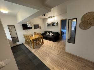 a living room with a table and a black couch at Downtown Reykjavík Apartments in Reykjavík