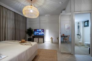 a bedroom with a bed and a television in a room at Akissare in Kámpos