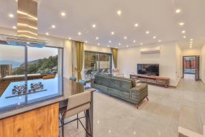 a living room with a couch and a table at SHB Villas Kalkan in Kaş