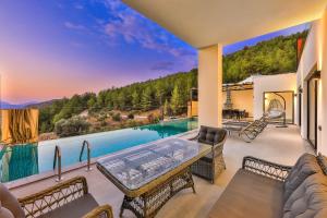a house with a view of a swimming pool at SHB Villas Kalkan in Kaş