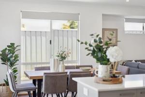 a living room with a table and chairs at The Tobias in Perth