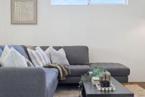 a living room with a couch and a coffee table at The Tobias in Perth +33 photos