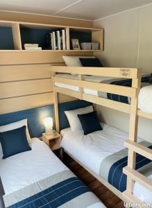 two bunk beds in a small room with at camping du Coucou in Nailhac