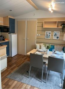 a kitchen and dining room with a table and chairs at camping du Coucou in Nailhac