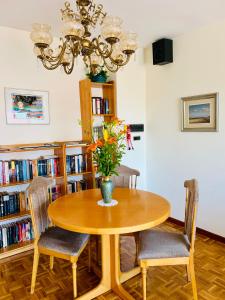 a dining room table with chairs and a vase with flowers at Piso céntrico y luminoso in León