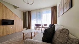 a living room with a couch and a table at Waterside Houses in Ognyanovo