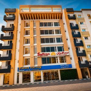 an apartment building with a sattler sign on it at Saffron Hotel and Lounges in Muscat