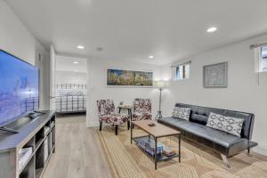 a living room with a couch and a table at Charming Washington Park Getaway in Denver