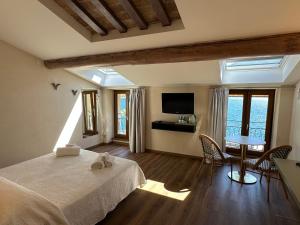 a bedroom with a bed and a table with chairs at Albergo Bellavista in Limone sul Garda