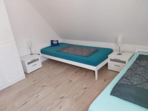 a bedroom with a bed and two night stands at Herrmanns-Ferienhaus Steigerwald in Schlüsselfeld +26 photos