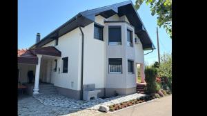 a white house with a black roof at Apartman Lili in Bihać