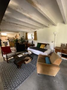 a living room with a bed and a couch at le relais Perrusson, Bed and breakfast et camping à la tuilerie in Écuisses