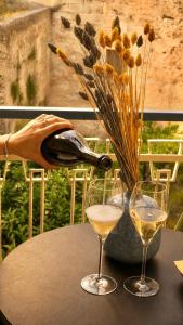 a table with two glasses and a bottle of wine at Vittorio Veneto Dimore in Bari +45 photos