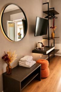 a bathroom with a mirror and a table with towels at Vittorio Veneto Dimore in Bari