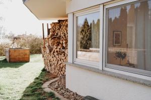 a pile of fire wood next to a window at Gemütliche Ferienwohnung in Riedlingen
