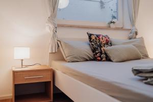 a bedroom with a bed with a lamp and a window at Gemütliche Ferienwohnung in Riedlingen