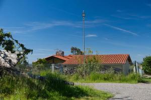 a house with a red roof on a street at Pepe Pastora in Arroes
