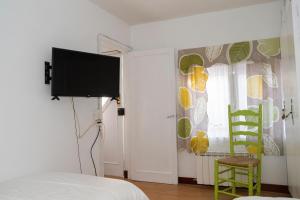 a bedroom with a bed and a tv and a window at Pepe Pastora in Arroes
