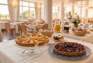a table with two pies and other food on it at Eden Torre Canne in Torre Canne
