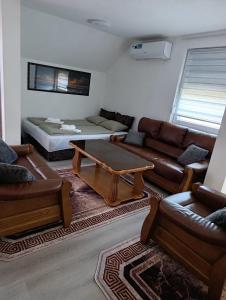 a living room with a couch and a table at Apartman Lili in Bihać