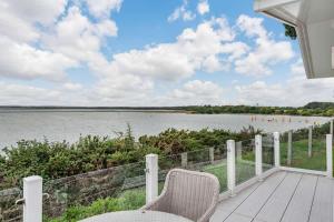 a porch with a view of a body of water at Bay View 2-Bed Lodge with Glorious Harbour View and Balcony in Poole