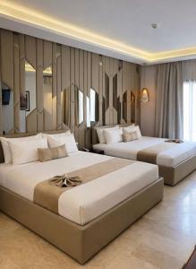 two beds in a hotel room with two bedsvisor at One Hotel Casablanca in Casablanca