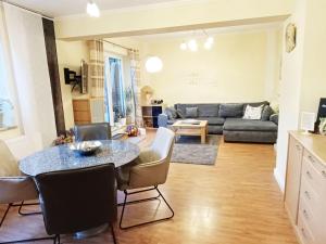 a living room with a table and a couch at Ferienhaus-Kassiopeia in Laboe