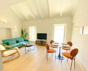 a living room with a couch and a table and chairs at Metropolis Nextdoor in Vathi