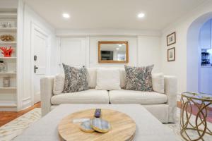 a living room with a white couch and a table at Garden Level 2 bed 2 bath Apartment in Historic District in Savannah