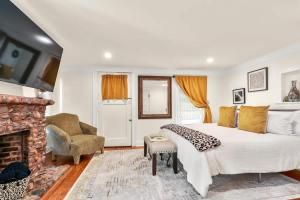 a bedroom with a large bed and a fireplace at Garden Level 2 bed 2 bath Apartment in Historic District in Savannah
