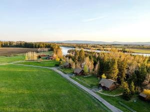 an aerial view of a village with a river and trees at Glacier River Ranch - South Fork in Columbia Falls