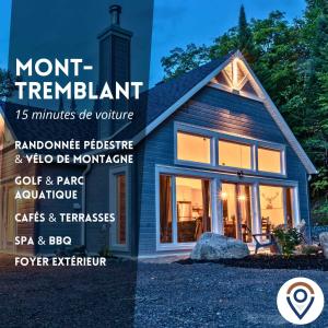 a home with a month rental sign in front of a house at Le Mésangeai in Lac-Superieur