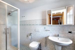 a bathroom with a sink and a toilet and a shower at Chalet vista Monte Bianco in La Salle +23 photos