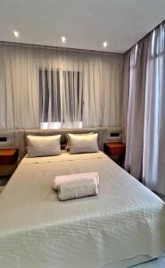 a bedroom with a large bed with a towel on it at villa la perle in Asilah +33 photos