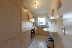 a small kitchen with a sink and a counter at FW2 Deichperle in Wremen +9 photos