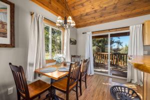 a dining room with a wooden table and chairs at Glacier River Ranch - North Fork in Columbia Falls +18 photos