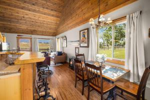 a kitchen and living room with a table and chairs at Glacier River Ranch - North Fork in Columbia Falls