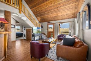 a living room with a couch and a table at Glacier River Ranch - North Fork in Columbia Falls
