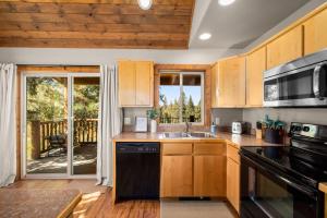 a kitchen with a sink and a stove at Glacier River Ranch - North Fork in Columbia Falls
