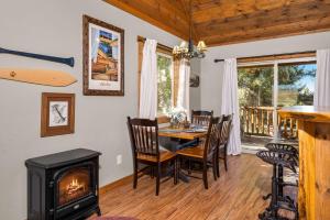 a dining room with a fireplace and a table with chairs at Glacier River Ranch - North Fork in Columbia Falls