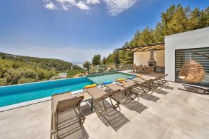 a patio with a table and chairs next to a swimming pool at SHB Villas Kalkan in Kaş
