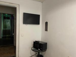 a flat screen tv on a wall in a room at Good Dreams in Kyiv