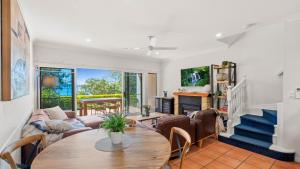 a living room with a table and chairs at Tinaroo Lodge Lakeview Escape with Pool Access in Tinaroo