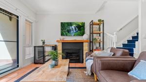 a living room with a couch and a fireplace at Tinaroo Lodge Lakeview Escape with Pool Access in Tinaroo