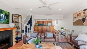 a living room with two chairs and a fireplace at Tinaroo Lodge Lakeview Escape with Pool Access in Tinaroo +22 photos