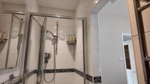 a shower in a bathroom with a glass door at Hallbottom Farm Cottage in Stokenchurch +10 photos