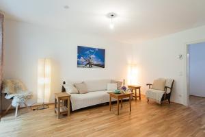 a living room with a white couch and a table at Appartment am Mondsee in Mondsee