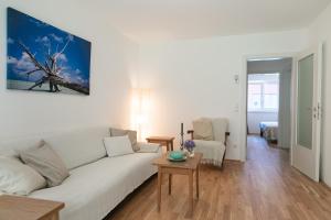 a living room with a white couch and a table at Appartment am Mondsee in Mondsee +21 photos